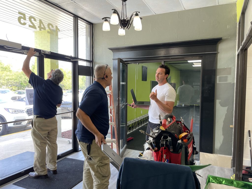 Michael Benso, BUZOPS co-Founder assisting in the installation of the new 24-Hour Access System ​at EnerGym North JAX and making sure all members walking in have immediate access to the gym and their attendance is accurately reflected in their members account in BUZOPS.